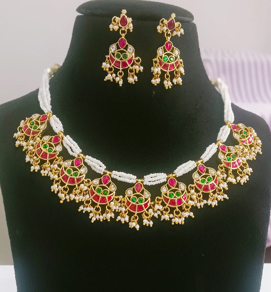 Pendant necklace featuring a charm chain